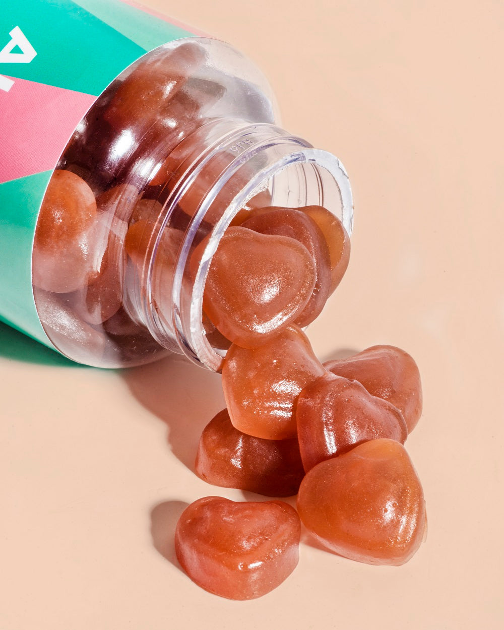 Complete-PMS-Heart-shaped-vitamins-spilling-out-of-bottle-to-show-texture-and-quality